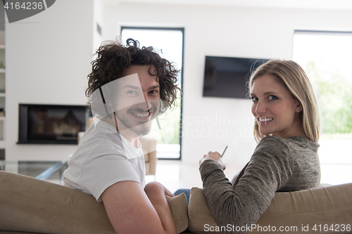 Image of Rear view of couple watching television