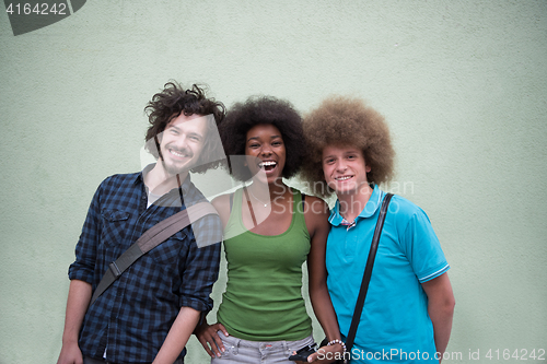 Image of multiethnic group of happy three friends