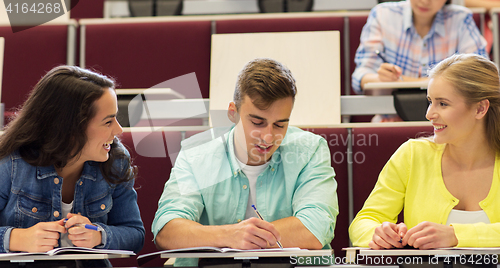 Image of group of students with notebooks in lecture hall