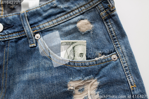 Image of dollar money in pocket of denim pants or jeans