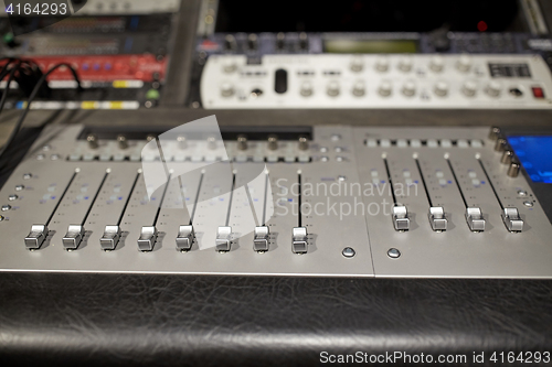 Image of music mixing console at sound recording studio