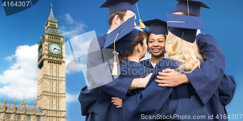 Image of happy students or bachelors hugging