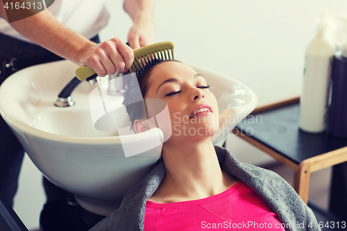 Image of happy young woman at hair salon