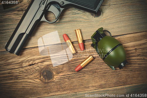 Image of hand gun, grenade and cartridges