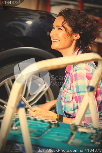 Image of beautiful smiling woman car mechanic
