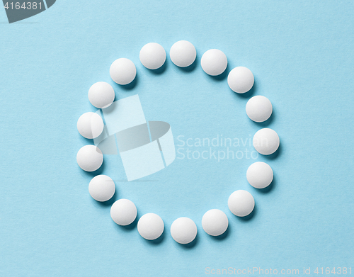 Image of white pills on blue background