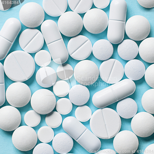 Image of white pills on blue background