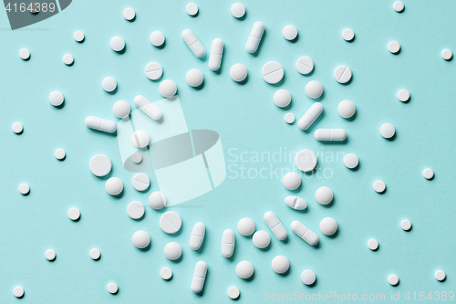 Image of white pills on blue background