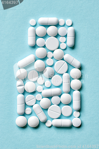 Image of white pills on blue background