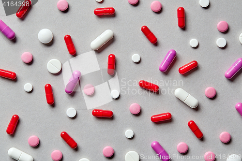 Image of colorful pills on grey background