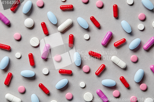 Image of colorful pills on grey background