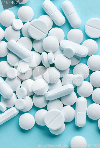 Image of white pills on blue background