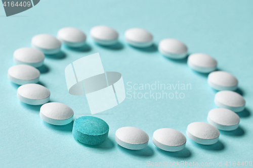 Image of white pills on blue background