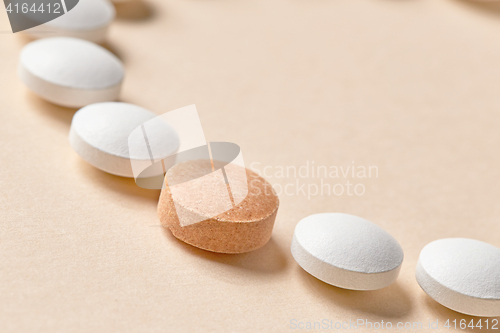 Image of white and orange pills