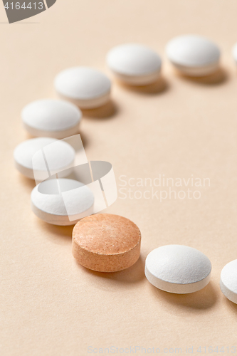 Image of white and orange pills