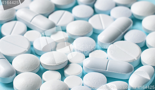 Image of white pills on blue background