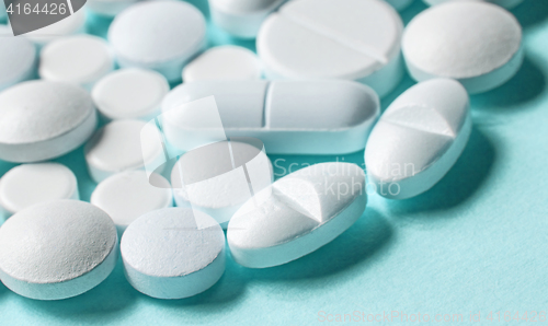 Image of white pills on blue background