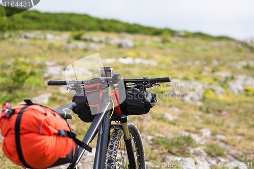 Image of Bicycle with orange bags for travel