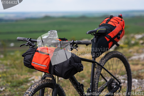 Image of Bicycle with orange bags for travel