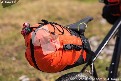 Image of Bicycle with orange bags for travel