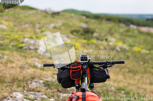 Image of Bicycle with orange bags for travel