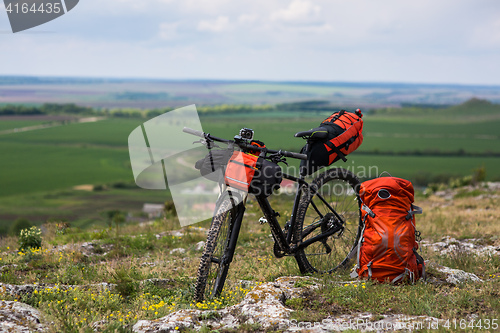 Image of Bicycle with orange bags for travel