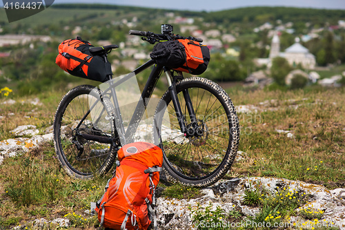 Image of Bicycle with orange bags for travel