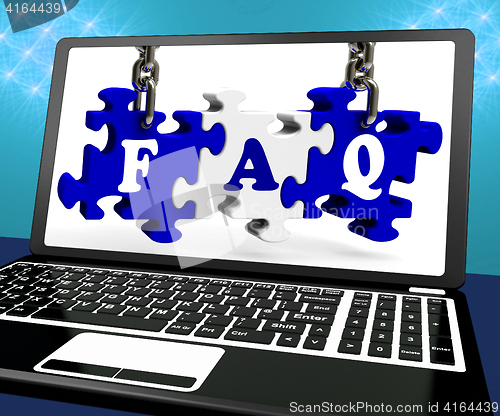 Image of FAQ Puzzle On Laptop Shows Website Assistance