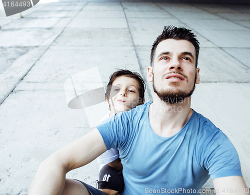 Image of mature father with his son under the bridge having fun together 