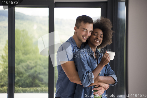 Image of romantic happy young couple relax at modern home indoors