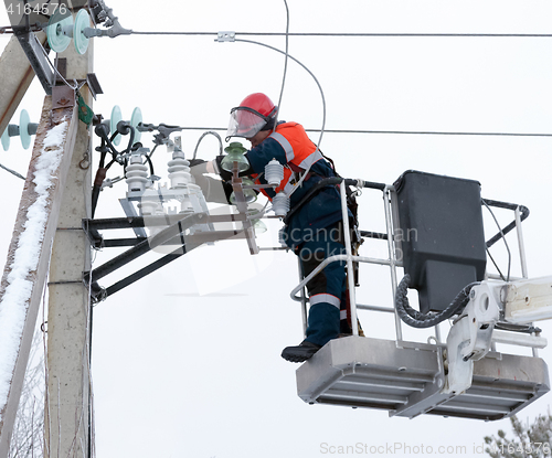 Image of Electrician connect the wires to the line isolator