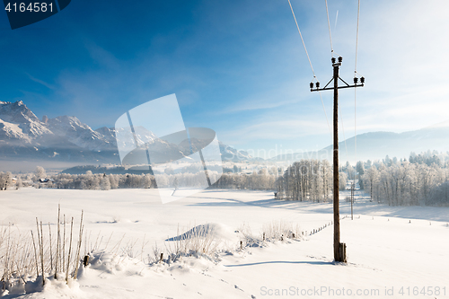 Image of Austrian Winter Wonderland with mountains, fresh snow and haze in the sunlight