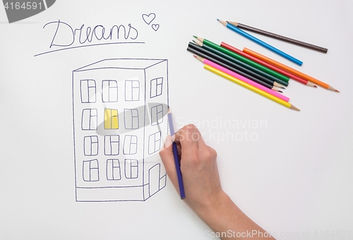 Image of Hand painted on the drawing paper with crayons multi-storey building, light in the apartment and the inscription dream