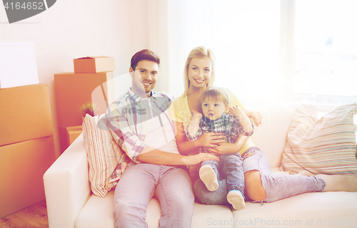 Image of happy family with boxes moving to new home