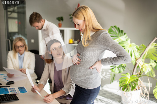 Image of happy business team with papers in office