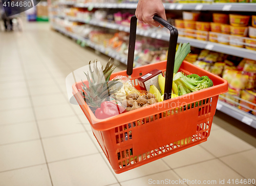 Image of woman with food basket at grocery or supermarket