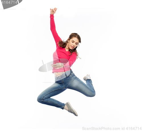 Image of smiling young woman jumping in air