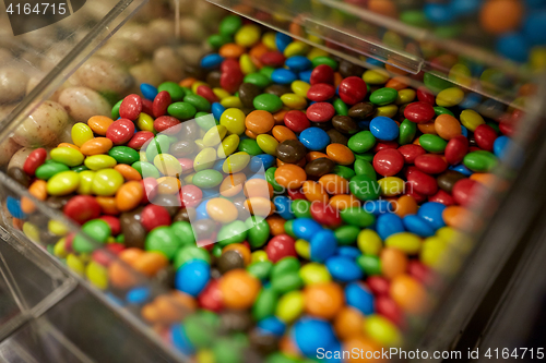 Image of close up of multicolored dragee candies in box