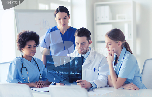 Image of group of doctors discussing x-ray image