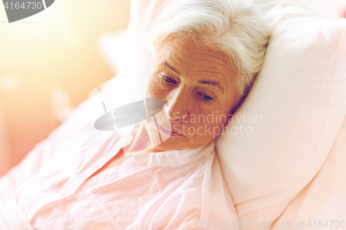 Image of senior woman patient lying in bed at hospital ward