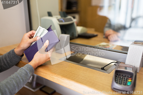 Image of hands with money at bank or currency exchanger