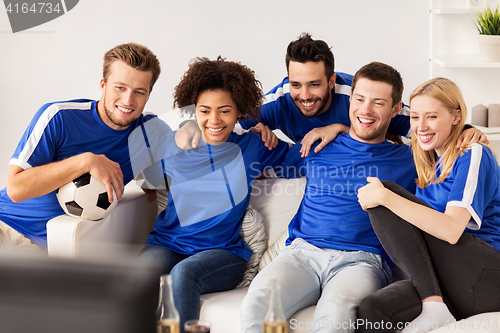 Image of friends or football fans watching soccer at home