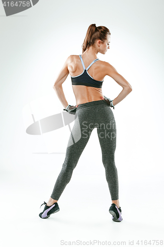 Image of Muscular young woman athlete on white