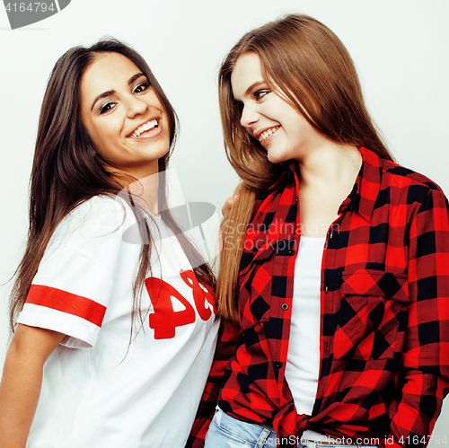 Image of best friends teenage girls together having fun, posing emotional on white background, besties happy smiling, lifestyle people concept, blond and brunette multi nations 