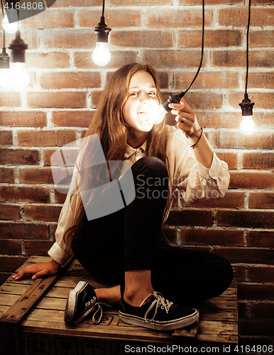 Image of pretty teenage girl having fun in stylish modern loft studio, lifestyle people concept 