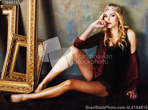 Image of young blond woman wearing crown in fairy luxury interior with em