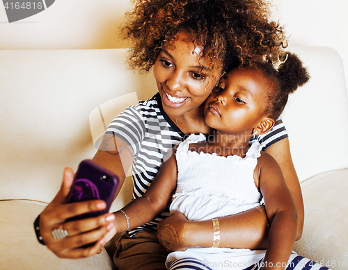 Image of adorable sweet young afro-american mother with cute little daugh