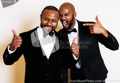 Image of two afro-american businessmen in black suits emotional posing, g