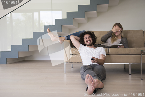 Image of young couple relaxes in the living room