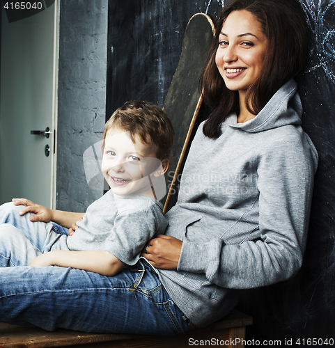 Image of young hipster teenage girl sitting with her brother in classroom